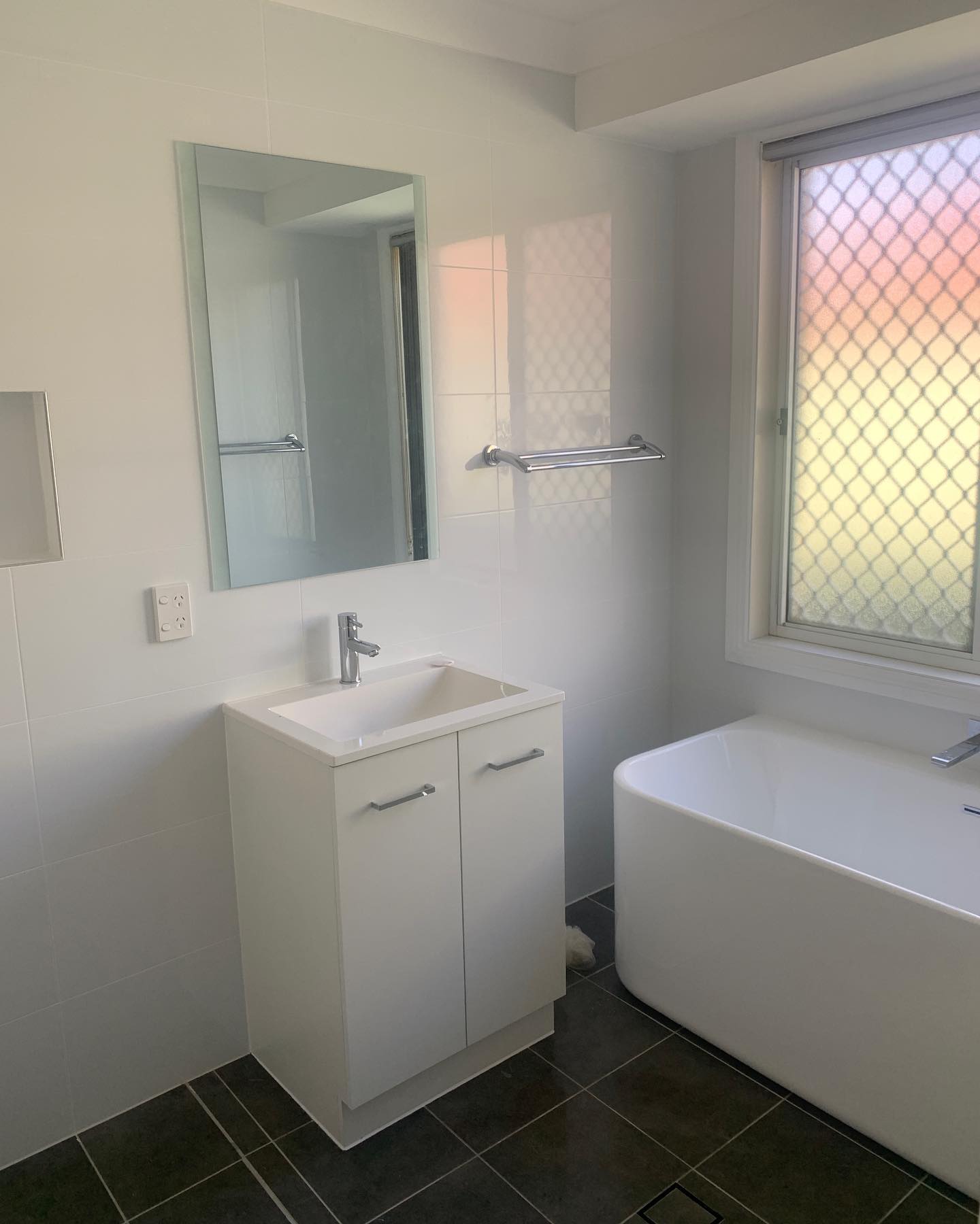 Bathroom after — new vanity, mirror and freestanding bath