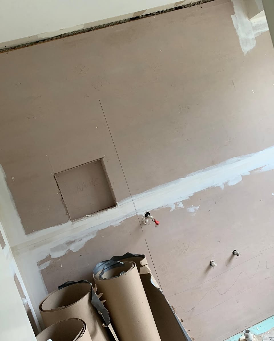 Bathroom in progress — fresh plasterboard and waterproofing
