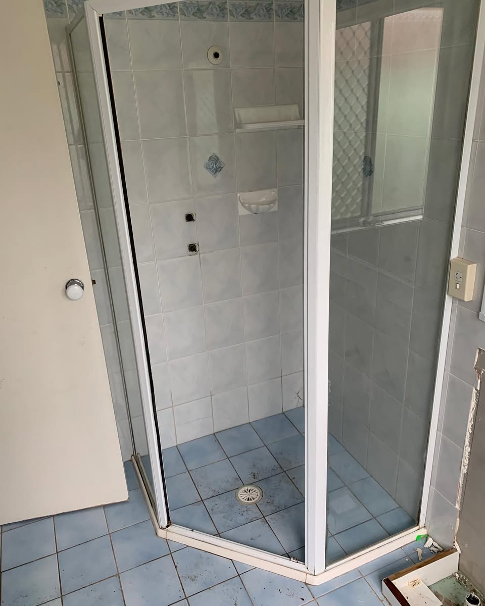 Bathroom before — original shower enclosure