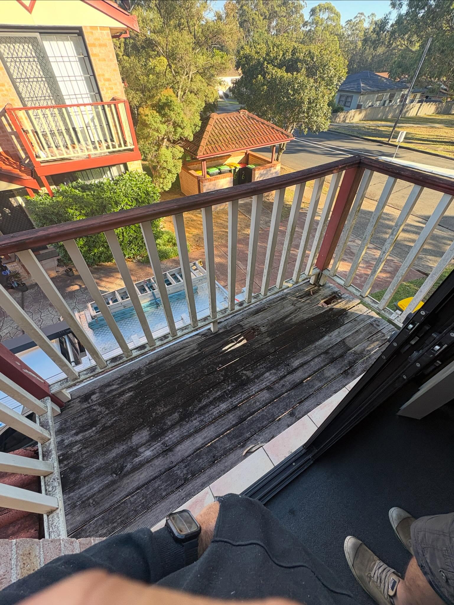 Balcony before — rotted timber deck boards