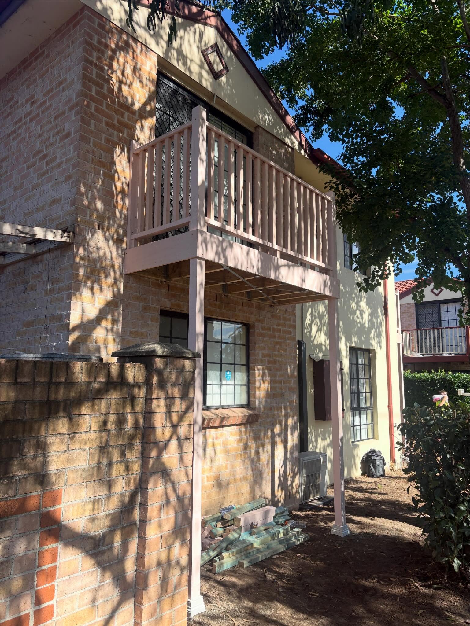 Balcony during rebuild — new timber frame and balustrade